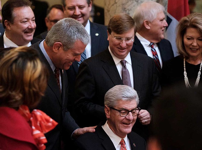 Mississippi House Speaker Philip Gunn put his hand on Gov. Phil Bryant's shoulder as the state's top Republican signed the Mississippi Broadband Enabling Act into law in January.