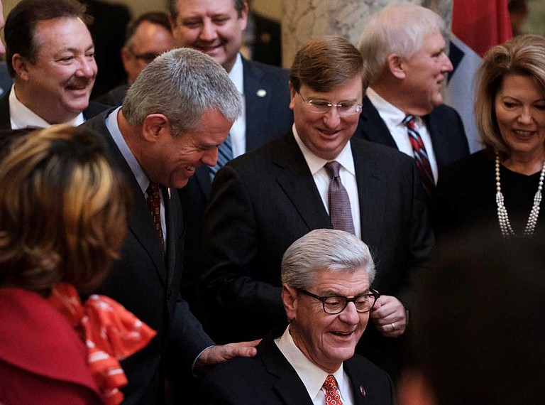 Mississippi House Speaker Philip Gunn put his hand on Gov. Phil Bryant's shoulder as the state's top Republican signed the Mississippi Broadband Enabling Act into law in January.