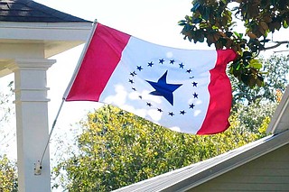 Laurin Stennis says her flag design represents unity. It has red vertical bars on each side and a white center with a large blue star encircled by 19 smaller ones, representing Mississippi as the 20th state. Photo courtesy Stennis Flag Flyers