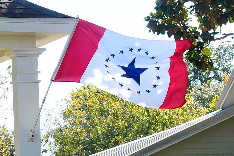 Laurin Stennis says her flag design represents unity. It has red vertical bars on each side and a white center with a large blue star encircled by 19 smaller ones, representing Mississippi as the 20th state. Photo courtesy Stennis Flag Flyers