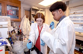 Murrah High School seniors Maggie Jefferis (left) and Kilando Chambers (right) do work as part of Base Pair, which pairs Murrah students on research projects with UMMC doctors. Photo by Jay Ferchaud/UMMC Photography