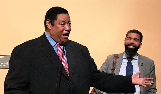 Mayor Chokwe Lumumba (right) is all smiles as Councilman Kenneth Stokes of Ward 3 (left) speaks to those assembled at the May 14 Jackson City Council meeting.