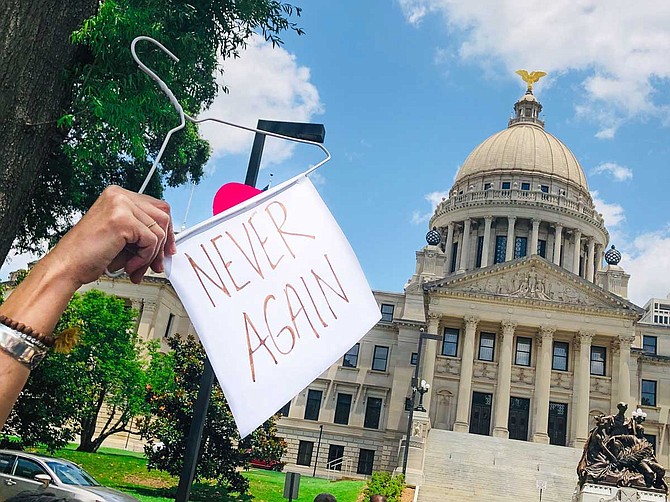 Yazoo City resident Mindy Brown protested for abortion rights outside the Mississippi Capitol on May 21 with this prop—an allusion to a pre-Roe era when women used hangers to self-induce abortions, often with deadly results.