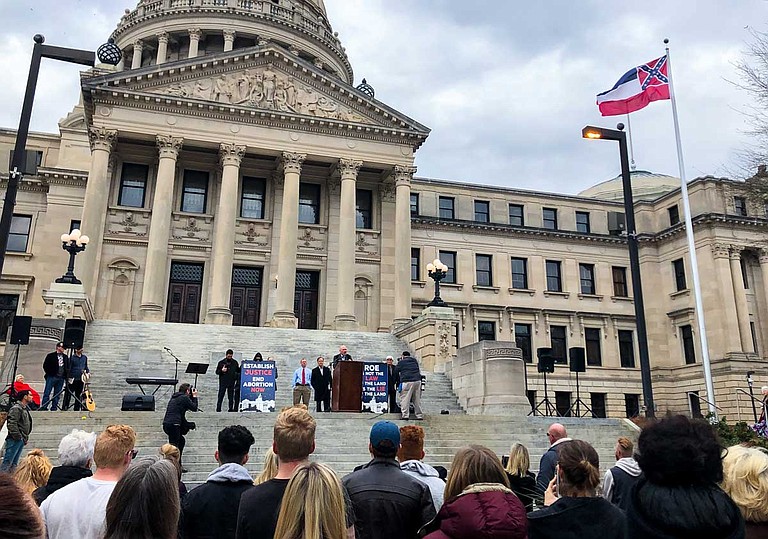Operation Save America, an anti-abortion extremist organization, calls for an end to abortion in Mississippi from the steps of the state Capitol building on Jan. 22, 2019. One placard, referring to the 1973 U.S. Supreme Court Roe v. Wade case that legalized abortion nationwide, reads: "Roe Is Not the Law of the Land, It Is the Lie of the Land."