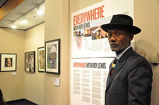 Roy Lewis, photographer, stands beside his "Everywhere with Roy Lewis" exhibit at Jackson State University in April 2019. Photo courtesy Roy Lewis