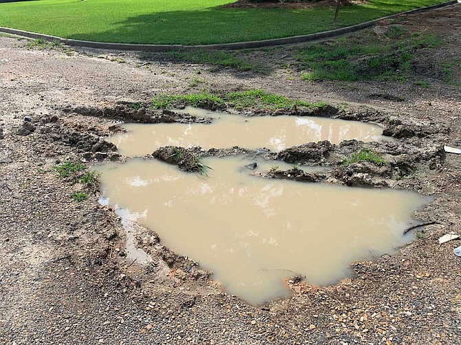 A large pothole sits in the middle of Amanda Lane in the Brookleigh Hills subdivision in South Jackson. Photo by Josh Wright