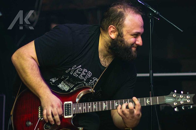 Tyler Holden (pictured) is the guitarist and lead vocalist for The Hero and A Monster. Ethan Mannon is the drummer and a vocalist. Photo courtesy Alden Kirkland Photography