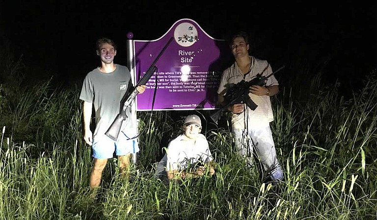 Three University of Mississippi students posed with rifles for a photo next to the bullet-riddled Emmett Till Marker in Tallahatchie County. They posted it on Instagram. Photo courtesy Instagram vis MCIR