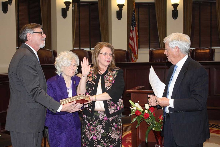 Donna Barnes (center) at her swearing in ceremony. With Judge Barnes at left are her brother Paul Barnes and mother Ouida Barnes. At right is Supreme Court Chief Justice Mike Randolph, who administered the oath. Photo courtesy Mississippi Courts