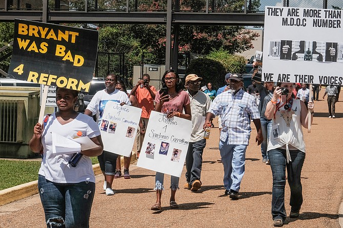 Community members marched to end practices that they say incarcerate far too many people for far too long, often for nonviolent crimes at a rally in Brandon, Miss., on July 29, 2019. Malaika Canada, left, says her son pleaded guilty and accepted a life sentence for a crime she believes he did not commit. Photo by Ashton Pittman
