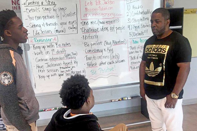 Cedric Willis, who was in prison for 12 years for a murder he didn’t commit, talks to Youth Media Project students Dartavious Archie (left) and Marquavious Harris in spring 2017. The students were part of the Wingfield High School FAME program. Photo by Donna Ladd