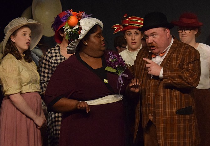 In Black Rose Theatre's production of "The Music Man," Brittany Butler (left) stars as the mayor's wife, Eulalie Shinn, and Chris Roebuck (right) stars as con artist Harold Hill. The cast includes more than 30 people in the ensemble. Photo by Andrew Overton