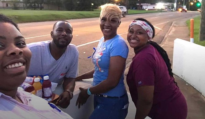 The family of Cedric Willis joined a deep conversation about preventing violence at Walton Elementary School on Aug. 1. Pictured from left: Youth Media Project organizer Leslyn Smith, Ryan Willis, Alana Willis and Josalyn Johnson. Photo courtesy Leslyn Smith