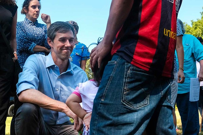 At a stop in Canton, Miss., Democratic presidential candidate Beto O'Rourke speaks with a little girl whose mother was taken in an ICE raid in town the week before. Her father, who has two other children, said ICE is still holding his wife at a facility two hours away. Photo by Ashton Pittman