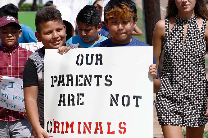 Children of mainly Latino immigrant parents hold signs in support of them and those individuals picked up during an immigration raid at a food processing plant, during a protest march to the Madison County Courthouse in Canton, Miss., on Aug. 11, 2019. Photo by Rogelio V. Solis via AP