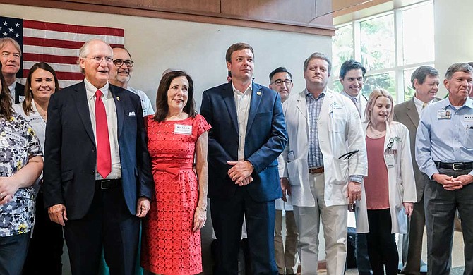 Former Mississippi Supreme Court Chief Justice Bill Waller (first left) stands next to his wife, Charlotte Waller (second left), and former opponent-turned endorsee Robert Foster (third left), at an event with medical professionals and administrators at the Hattiesburg clinic in Hattiesburg, Miss., on Aug. 13, 2019. Waller was there to tout his "Medicaid reform" plan and to accept Foster's endorsement. Photo by Ashton Pittman