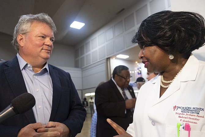 Jim Hood, the Democratic nominee for governor, speaks with Dr. Lynda Jackson-Assad following a press conference at the Jackson Medical Mall on Aug. 28, 2019. Hood stressed the importance of health-care reform for Mississippians in his remarks. Photo by Seyma Bayram
