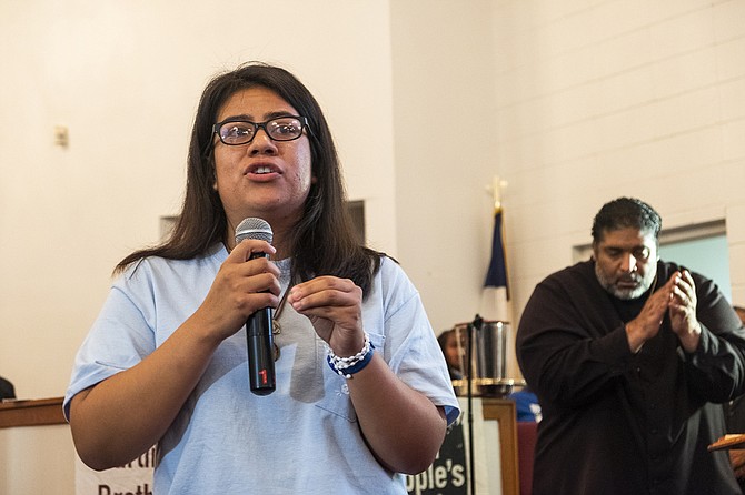 Daisey Martinez, left, a community organizer working to help families the recent Mississippi ICE raids targeted, delivers her testimony alongside Rev. Dr. William J. Barber II (right) at a mass meeting at the Liberty Missionary Baptist Church in Canton, Miss., on Aug. 29, 2019. Photo by Seyma Bayram