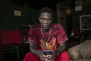 Joshua K. Love sits in the living room of his home in Greenwood, Miss., Saturday, June 8, 2019. Love says he was sexually abused by two Franciscan friars at a local Catholic grade school. Photo by Wong Maye-E via AP