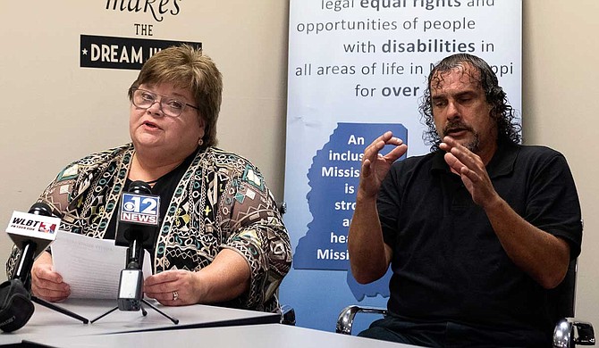 Disability Rights Mississippi Executive Director Polly Tribble (left) and sign-language translator Greg Goldman (right) address reporters during a press conference at her office in Jackson on Sept. 5, 2019. Tribble responded to U.S. District Court Judge Carlton W. Reeves' ruling that Mississippi is violating the civil rights of residents with mental-health issues. Photo by Seyma Bayram.