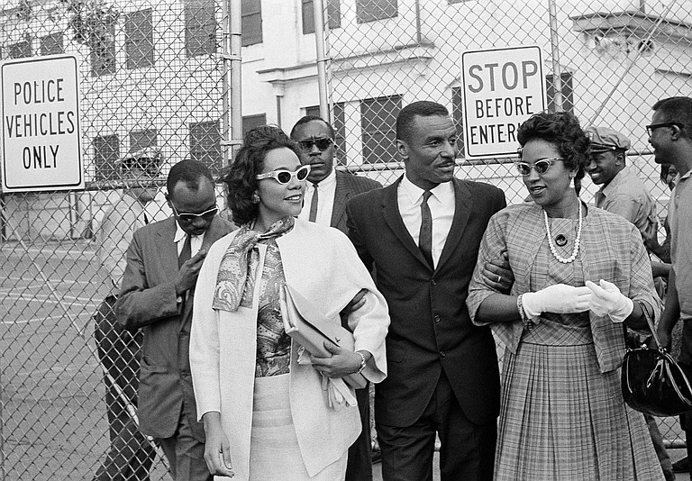 In this April 18, 1963 file photo, Coretta Scott King, left, the Rev. Fred L. Shuttlesworth, center, and Mrs. Juanita Abernathy, leave Birmingham jail after visiting Rev. Martin Luther King, Jr. and Rev. Dr. Ralph Abernathy in Birmingham, Ala. Juanita Abernathy, who wrote the business plan for the 1955 Montgomery Bus Boycott and took other influential steps in helping to build the American civil rights movement, has died. She was 88. Family spokesman James Peterson confirmed Abernathy died Thursday, Sept. 12, 2019, at Piedmont Hospital in Atlanta following complications from a stroke. (AP Photo/File)