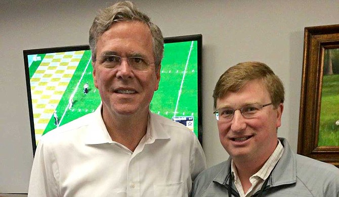Former Florida Gov. Jeb Bush (left), seen here with Lt. Gov. Tate Reeves (right) at a Mississippi State University game in 2015, is coming to the state next month to help the Republican nominee raise money in his bid for governor. Photo courtesy Jeb Bush/Facebook
