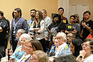 Fondren resident Scotta Brady, center left, stands with a few abortion-rights supporters amid a crowd of anti-abortion activists wearing yellow "Keep Jackson a Free Speech Zone" stickers at a Jackson City Council meeting on Sept. 26, 2019. Photo by Ashton Pittman.