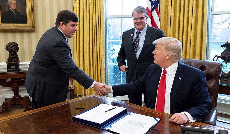 U.S. Rep. Steven Palazzo, R-Miss., left, shakes hands with President Donald Trump during a Spring 2019 meeting in the Oval Office.
