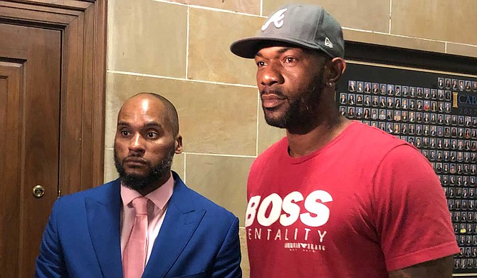 Dennis Sweet IV and John Knight, father of John Knight III, address reporters outside of a Hinds County courtroom after a judge ruled that a lawsuit accusing the City of Jackson of police brutality will move forward. Photo by Seyma Bayram