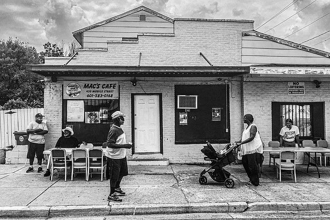 At the Mobile Street Renaissance Festival in downtown Hattiesburg, attendees gather outside Mac’s Café, a soul-food restaurant that is among just a handful of businesses that still operate in the historic black business district. At the height of Mobile Street’s glory days, it was the home 
of Williams Cab Co., a long-defunct taxi service company. Photo by Ashton Pittman