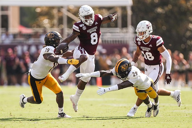 MSU running back, Kylin Hill rushes for the Bulldogs. Courtesy of MSU Athletics.