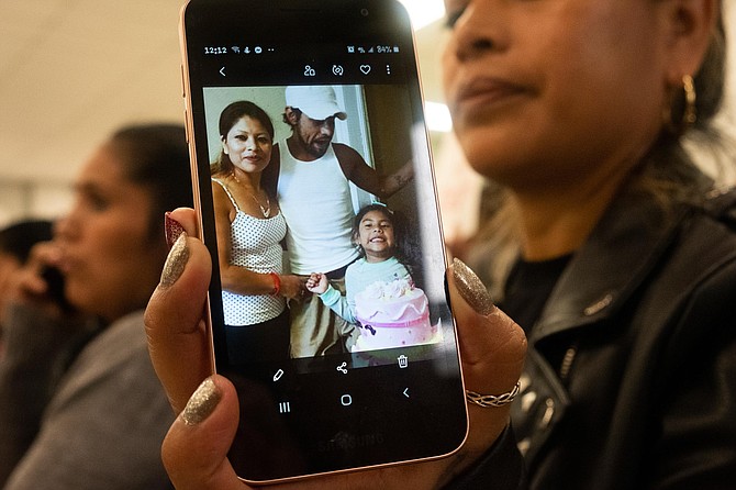 Hilda (last name withheld) shares a photograph of herself with her husband, Antonio, and daughter. Antonio remains in ICE custody, without a bond hearing, following the Aug. 7 raids in Mississippi. Photo by Seyma Bayram