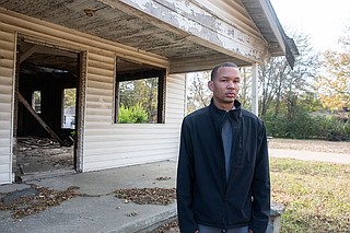 Terun Moore stands outside an abandoned house in the Washington Addition, one of three Jackson neighborhoods where a new credible-messenger and violence-interruption program aims to counsel residents at risk of committing violence. Photo by Seyma Bayram