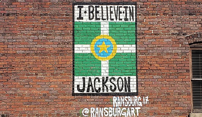 Local artist Justin Ransburg’s “I Believe in Jackson” art piece hidden is plain sight off East Capitol Street. Azia Wiggins believes in it, too. Photo by Azia Wiggins