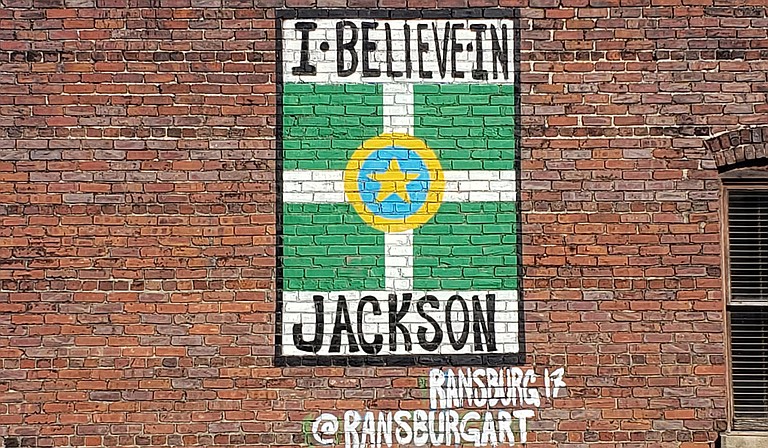 Local artist Justin Ransburg’s “I Believe in Jackson” art piece hidden is plain sight off East Capitol Street. Azia Wiggins believes in it, too. Photo by Azia Wiggins