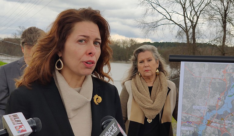 The Rankin Hinds Pearl River Flood & Drainage Control District, called the Levee Board, is confident that the "One Lake" project will address flood control in Jackson. But environmentalists, including Jill Mastrototaro, left, policy director for Audubon Mississippi, gathered in front of the Pearl with a presentation challenging their certainty. Mayor of Monticello, Miss., Martha Watts, right, joined them, sharing her fears of downstream effects on local industry. Photo by Nick Judin