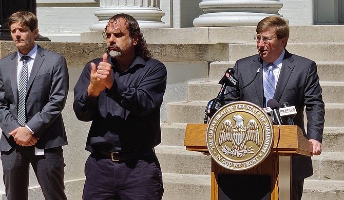 Ray Mabus, a former Mississippi governor and secretary of the U.S. Navy, says Gov. Tate Reeves (pictured at podium) must involve a strong shelter-in-place order in order to fight the spread of the coronavirus in Mississippi to replace the less-effective and confusing order he issued March 24. Photo by Nick Judin.