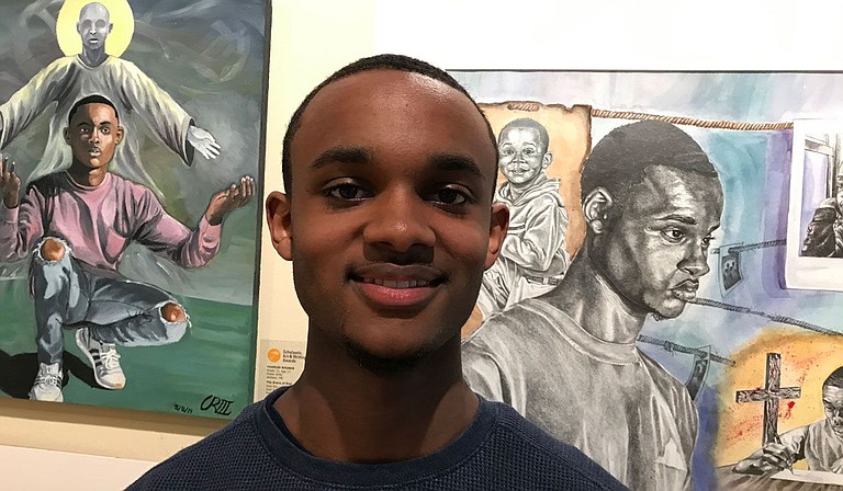 Murrah High School senior Charles Rounds stands with some of his artworks at a recent exhibition held at the Mississippi Museum of Art. Photo courtesy Sherry Lucas