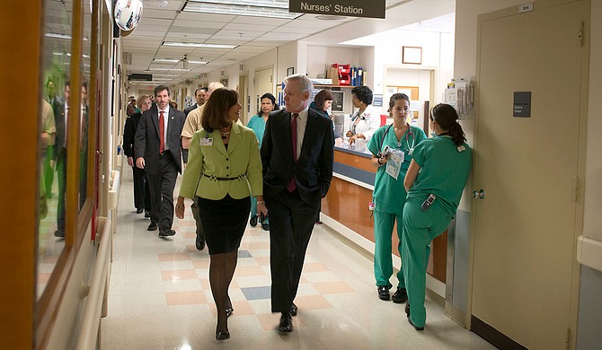 Secretary of the Navy Ray Mabus, right, spoke with Cathie Monge, the senior vice president for operations at Medstar Washington Hospital Center, during a Sept. 18, 2013 visit. When he was governor of Mississippi, he expanded Medicaid in every way he could, he says. U.S. Navy photo by Mass Communication Specialist 1st Class Arif Patani