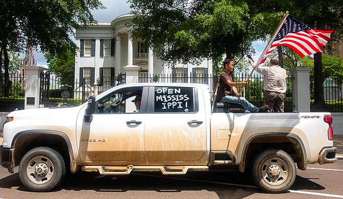 Protesters convened outside the Governor’s Mansion in downtown Jackson, Mississippi on April 25, 2020, to demand that Gov. Tate Reeves fully re-open the state during the novel coronavirus crisis. Photo by Seyma Bayram