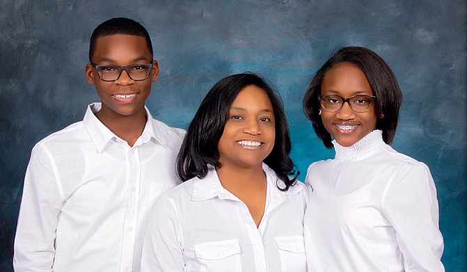 Dr. Erica Thompson (center) poses with her children, Connor and Sydnee. Photo courtesy Color Craft Studios