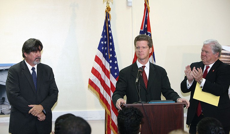 U.S. Housing and Urban Development Secretary Shaun Donovan (center), Gov. Haley Barbour (right) and Mississippi Center for Justice Housing Director Reilly Morse in North Gulfport in 2010 to announce a $132 million settlement of the Mississippi Center for Justice’s lawsuit against HUD over diversion of housing funds to expand the State Port at Gulfport. Photo courtesy of Mississippi Center for Justice