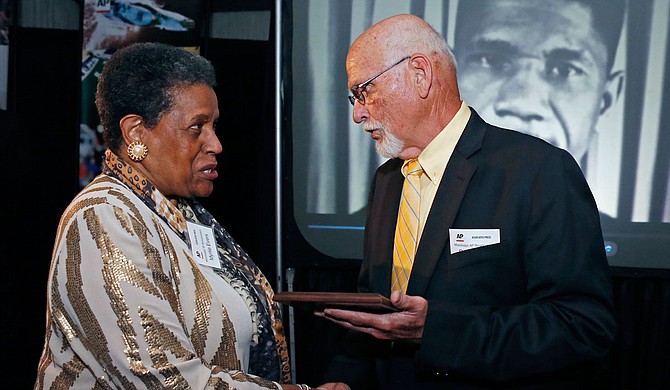 "In this April 26, 2014 file photo, Myrlie Evers-Williams, widow of the murdered Mississippi civil rights leader Medgar Evers, receives the 2014 Mississippi Associated Press Broadcasters Pioneers of Television award from retired Jackson, Miss., bureau Associated Press news editor Ron Harrist in Jackson, Miss. Harrist has died at the age of 77 of complications from leukemia. The Mississippi journalist had a four-decade career with the AP, covering Elvis Presley, black separatists, white supremacists and college football legends over the years. (AP Photo/Rogelio V. Solis, File)"