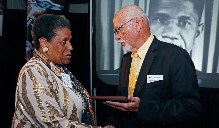 "In this April 26, 2014 file photo, Myrlie Evers-Williams, widow of the murdered Mississippi civil rights leader Medgar Evers, receives the 2014 Mississippi Associated Press Broadcasters Pioneers of Television award from retired Jackson, Miss., bureau Associated Press news editor Ron Harrist in Jackson, Miss. Harrist has died at the age of 77 of complications from leukemia. The Mississippi journalist had a four-decade career with the AP, covering Elvis Presley, black separatists, white supremacists and college football legends over the years. (AP Photo/Rogelio V. Solis, File)"