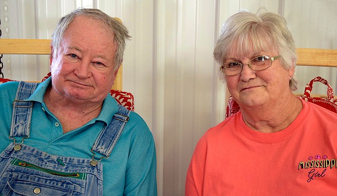 Doris Berry’s son John and his wife Brenda rest in rocking chairs at the family-owned farmers market. Photo by Michele D. Baker