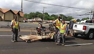 A road construction crew works on historic Robinson Road in late May. Photo by Kayode Crown