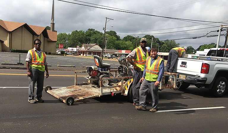 A road construction crew works on historic Robinson Road in late May. Photo by Kayode Crown