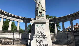 The words “spiritual genocide” in black spray paint, along with red handprints, stained the sides of a Confederate monument on the University of Mississippi campus Saturday, The Oxford Eagle reported. One person was arrested at the scene. Photo by Sarah Rankin via AP