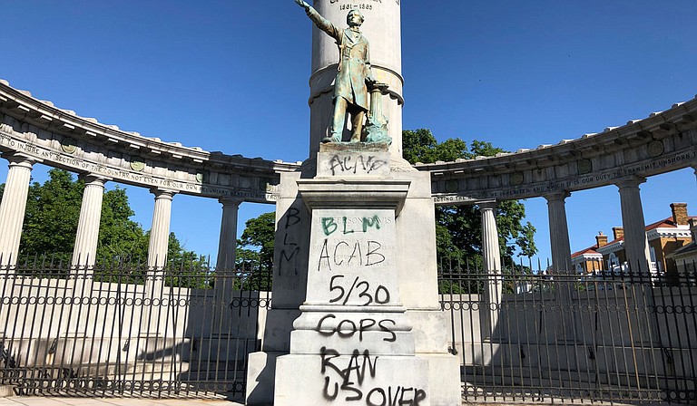 The words “spiritual genocide” in black spray paint, along with red handprints, stained the sides of a Confederate monument on the University of Mississippi campus Saturday, The Oxford Eagle reported. One person was arrested at the scene. Photo by Sarah Rankin via AP