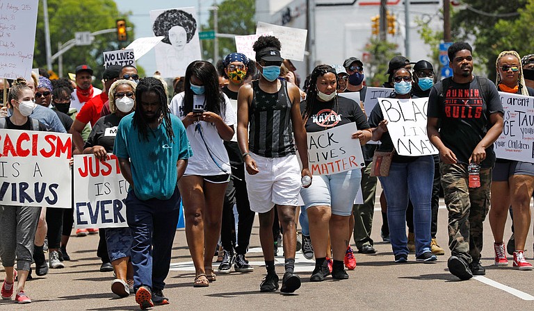 Protesters marched in Mississippi's capital city on Monday, with some stopping to lie on the ground outside Jackson's main police station to remember George Floyd, a black man who died after a Minneapolis police officer pressed his knee into Floyd's neck for several minutes. Photo by Rogelio V. Solis via AP
